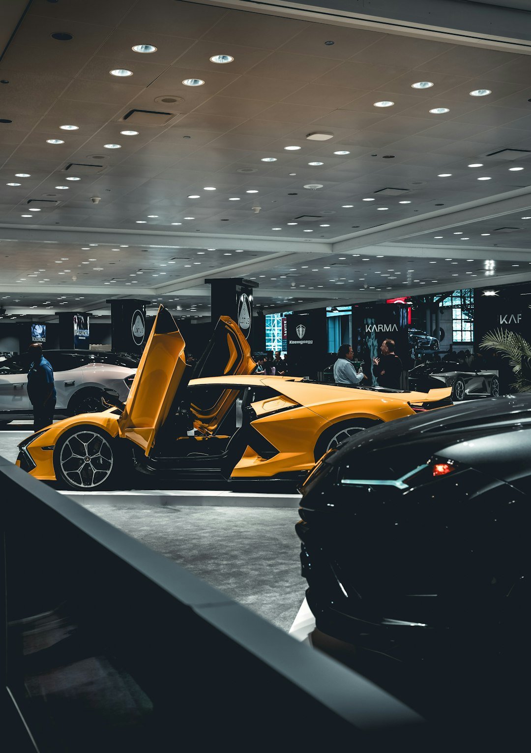 a-yellow-sports-car-parked-in-a-showroom-wfdhn6nwori